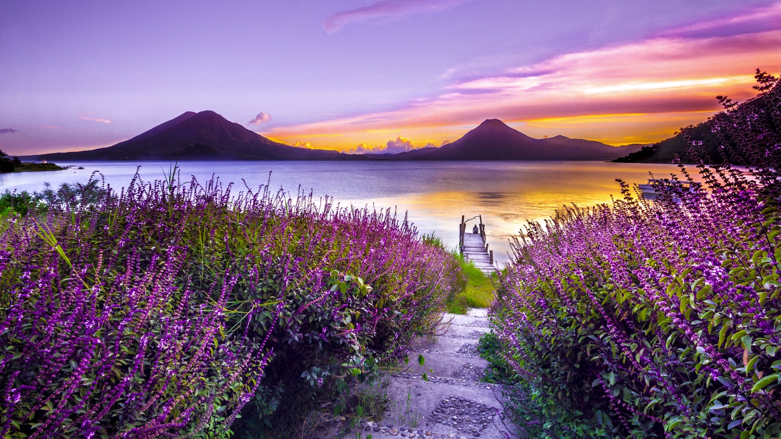 Close view of editing sliders being adjusted on a screen, a landscape photo visible behind them